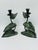 Brief description: Pair of vintage metal candlesticks featuring a nature-inspired design with lily pads, curved stems, and...