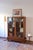Walnut glazed bookcase, 1960s, Art Deco in spirit. Two glazed doors in timber frames that lock with the original lock, and...