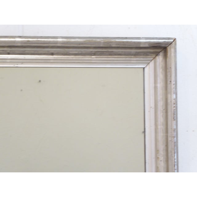 This silverleaf mirror is a fairly bright silver with an old patina including traces of old stenciling and measures 28"H x...