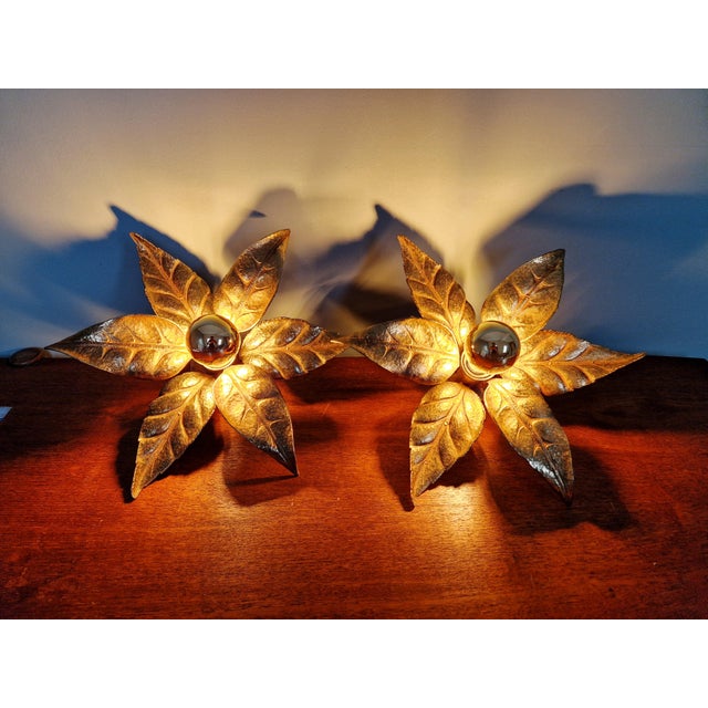 Pair of floral wall sconces in brass and gilt metal, hollywood regency style, designed by willy daro for the belgian...