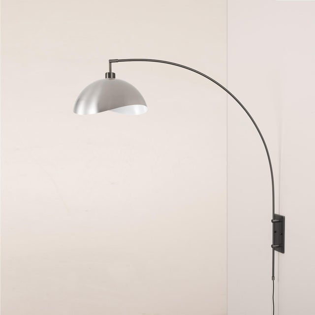 The Luna Bella Wall Arc Lamp is a sophisticated lighting piece that combines a sleek black nickel steel body with a satin...