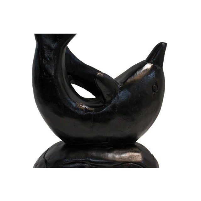 Our graceful dolphin sculpture is a professionally hand-crafted piece. Carved from solid wood with a simple black finish....
