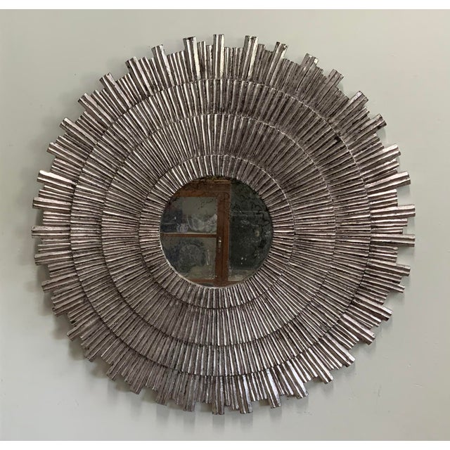 Striking large sunburst shape mirror. Silver leaf over black background. 30”in diameter. Mirror itself is 9” and...