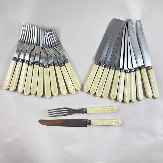 A service for twelve, Pearlized Bakelite handles and stainless steel flatware set, in the Art Deco style, circa early...
