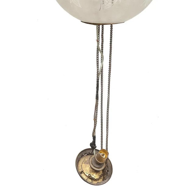 Art Nouveau suspension. Electrified. White glass globe decorated with a floral decor released with acid. Tin...