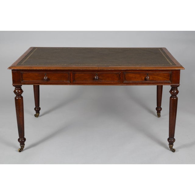 Early Victorian writing table with unusual configuration of drawers. There are three drawers on one side and two drawers...