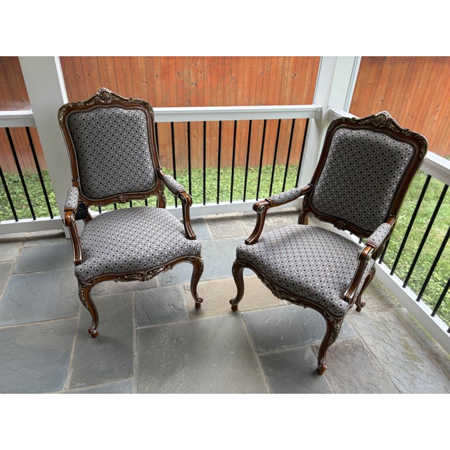 Set of two armchairs by Asnaghi Interiors, crafted in a Baroque Rococo style. The armchairs feature ornate carved wooden...