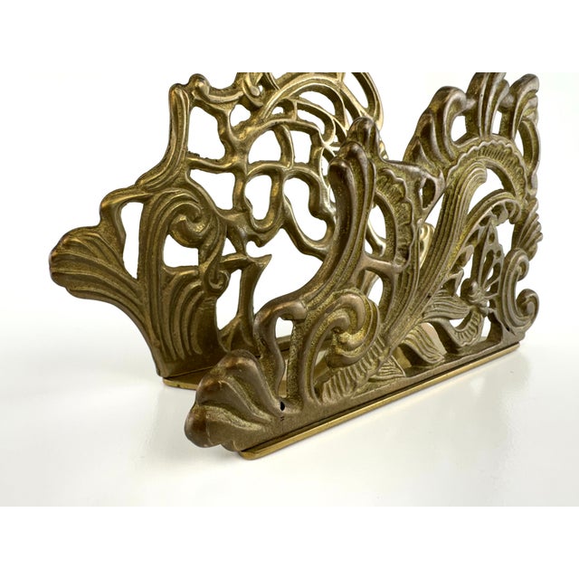 An elegant vintage cast brass letter holder featuring richly detailed Art Nouveau-inspired scrollwork and flowing...