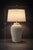 A sculptural 29” ribbed ceramic table lamp with a limestone-inspired finish and warm neutral tone. Featuring a deeply...