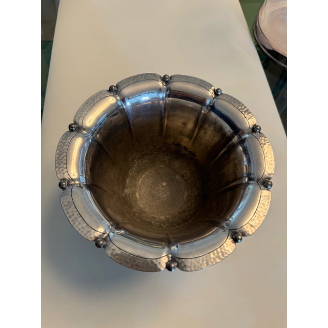 Small scalloped silver bowl with small accents and hand hammered in the edges. There is wear on the scalloped areas and...