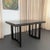 This Mid-Century Modern ebonized oak extension dining table was designed by the Hungarian born architect and interior...