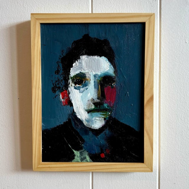 This portrait crackles with intensity, built from thick, deliberate strokes of paint that refuse to smooth themselves into...