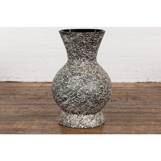 An artisan Prem Collection ceramic vase with nice rounded shape, black ground, white dripping décor and black glazed...