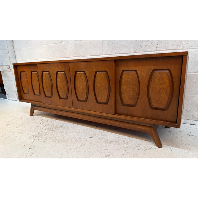 The walnut credenza by American furniture company Young Manufacturing displays eight gorgeous burl inlays across its...
