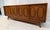 The walnut credenza by American furniture company Young Manufacturing displays eight gorgeous burl inlays across its...