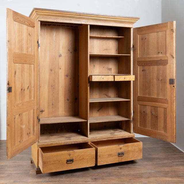 19th-century Swedish large two-door cabinet armoire crafted in pine. The piece retains its original painted finish along...