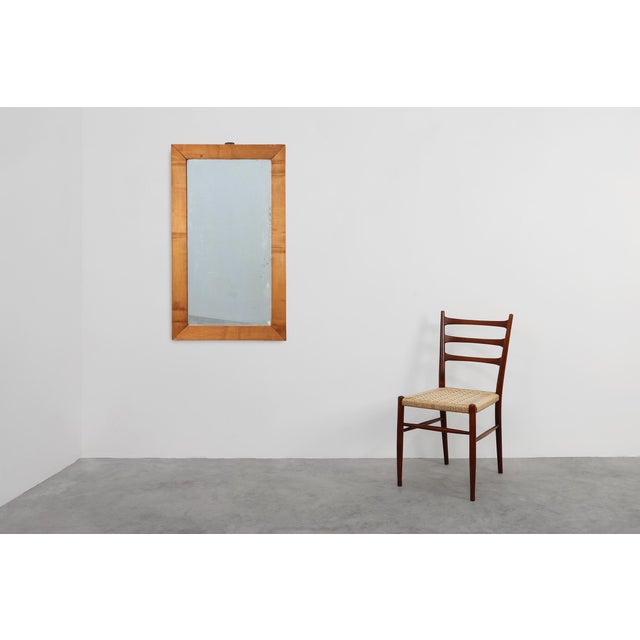 A characterful mid‑19th‑century English mirror in solid walnut, presenting a warm, naturally aged patina and a simple,...