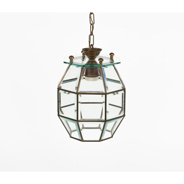 Midcentury amazing chandelier lantern in brass and beveled glass in the style of Adolf Loos. Made in Italy in the 1950s....