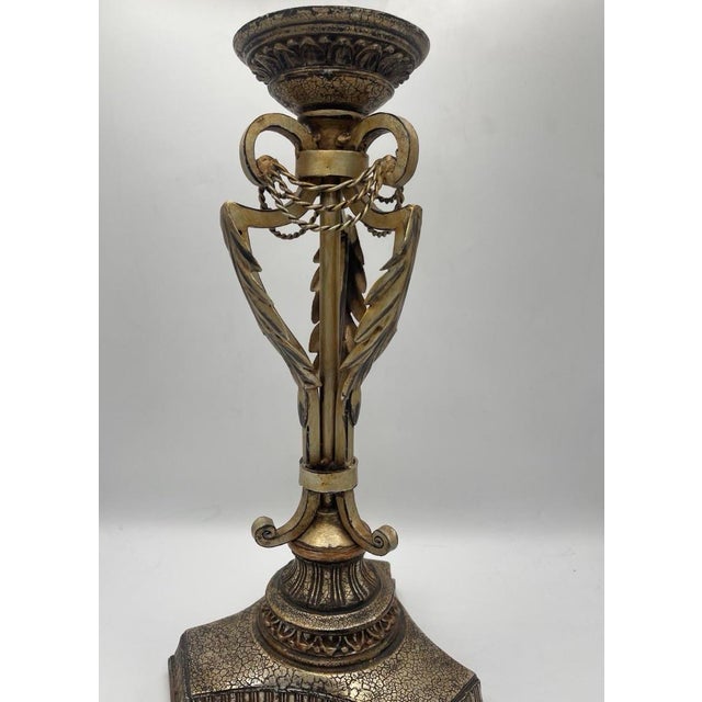 Elegant vintage Neoclassical-style brass candle holder featuring an ornate urn-form design with classical detailing and a...