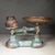 ABOUT A cast iron balance scale with bronze plated dish and embossed maker's mark "Lewis's 7lb". Three original cast iron...