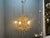 Elegant 1950s florentine tole chandelier with a beautifully gilded gold frame, adorned with cascading crystal garlands and...