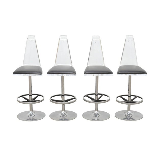 A striking set of four H Studio Trigo stools, these sculptural seats combine transparent acrylic, black leather, and...