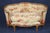 An exceptionally beautiful and very rare matched pair of French Louis XV-style settees, distinguished by their graceful...
