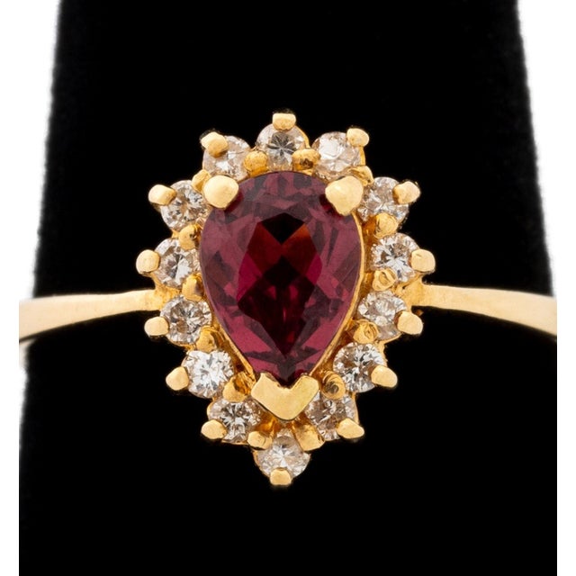 14K Yellow Gold Rubellite Diamond Ring, featuring one prong set pear brilliant cut rubellite weighing approx. 0.75 carat,...