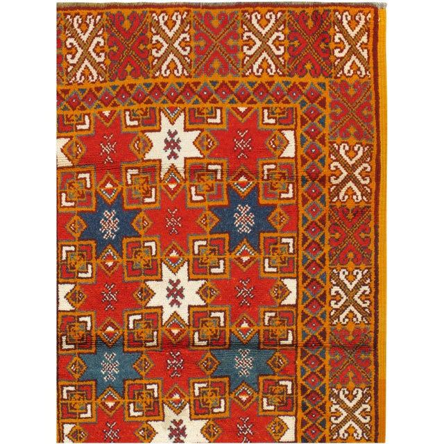 Vintage Moroccan hand-knotted wool rug with bold pattern and low pile.