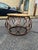 This stylish round wood and metal coffee table featuring a beautifully textured wood plank top paired with a sculptural...