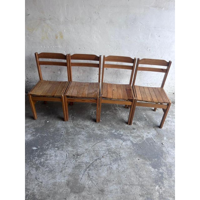 Set of four solid wood dining chairs with a straightforward, rustic construction and an attractive lived-in character....