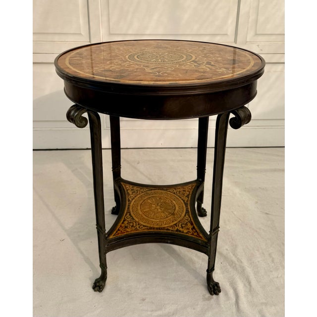 Here is a stunning vintage round side table, likely dating to the mid-20th century (circa 1950s–1970s), featuring a richly...