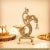 Illuminate your home with the divine glow of our Antique Gold Brass Peacock Diya with Hanging Bell. This masterfully...