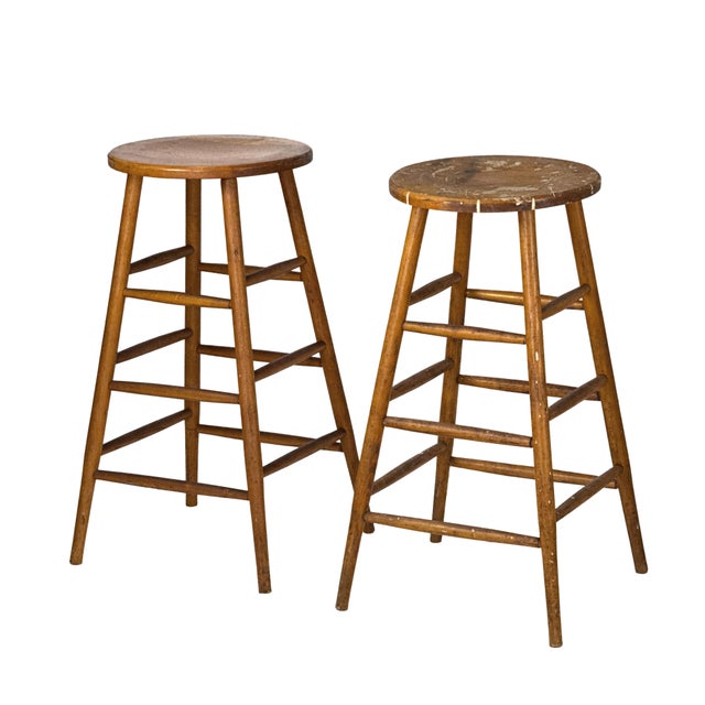 Vintage 1940s pair of matching tall hardwood artist's stools with round seats, splayed turned legs, and double-rung...