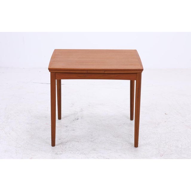 Extendable dining table by Poul Hundevad for Hundevad & Co. with clean lines and beautiful teak grain. The two integrated...