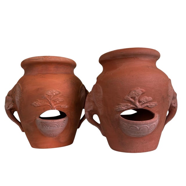 Vintage terracotta strawberry planter pots featuring an elegant elephant motif, dating to the late-20th century....