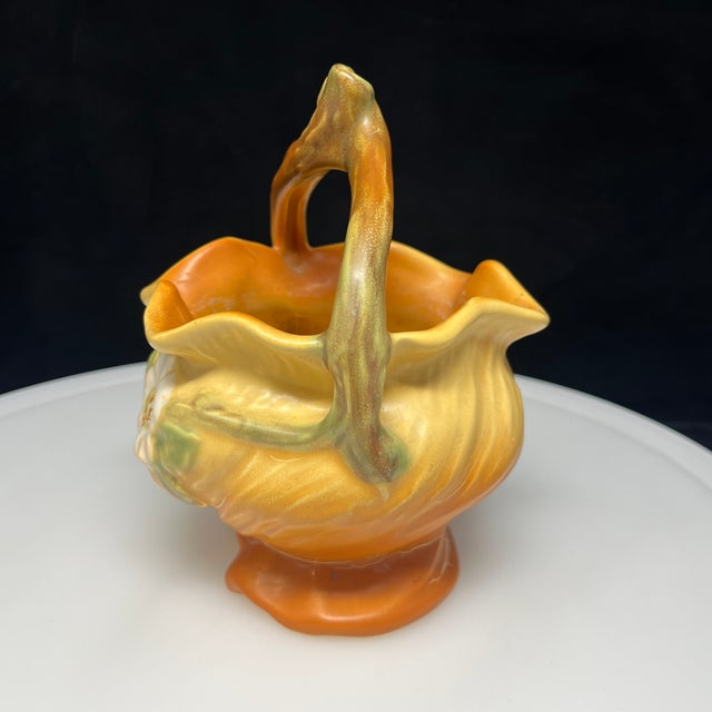 This vintage Weller piece is a unique and charming piece of art pottery. The bowl shape and handle add a practical element...