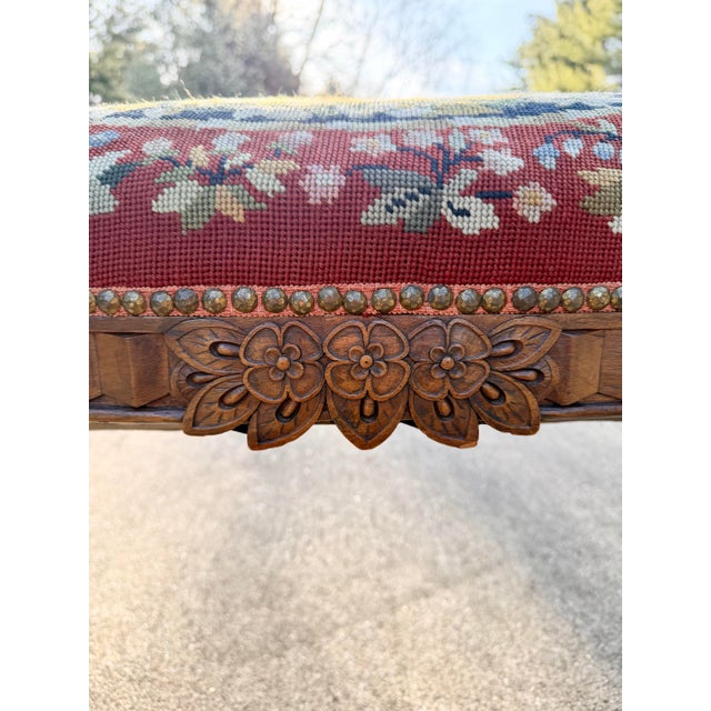 Beautiful window or end of bed bench made by Karpen, with a floral needlepoint tapestry featuring two ladies with a harp....