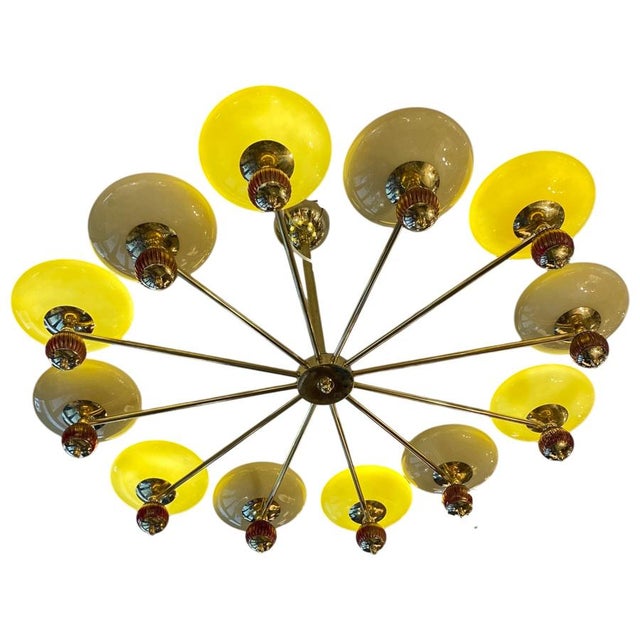 The lamp is arranged in a radial and horizontal pattern, suspended from a central brass stem that ends in a hemispherical...