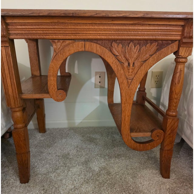 A very unique library / occasional table with floral vine motifs, creating stair step shelves. Has Arts & Crafts roots...