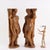 Pair of carved wooden sculptures depicting male figures. This piece is attributed to the mentioned designer/maker. It has...