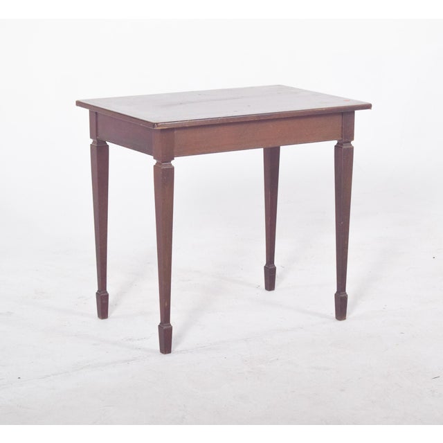 Side table in mahogany. Rectangular, it has straight edges and a flat surface, slightly marked by signs of use such as...