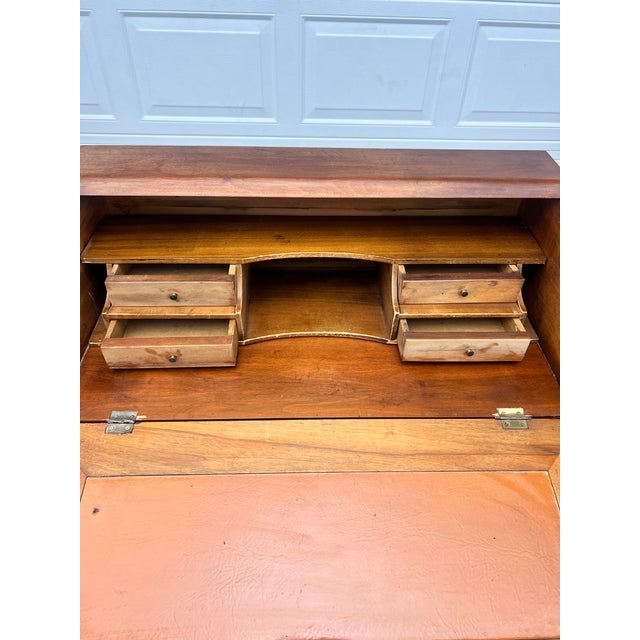 A charming French 19th century Louis XVI solid walnut secretary, featuring a slanted writing front, three drawers,...