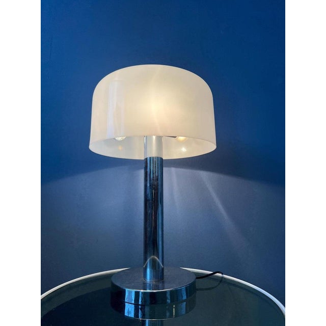 Large space age table lamp with shiny chrome base. The white acrylic mushroom shade creates a beautiful pure glow. The...