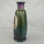 Antique iridescent art glass vase showcases a stunning peacock-inspired oil slick finish with deep blue, green, and purple...