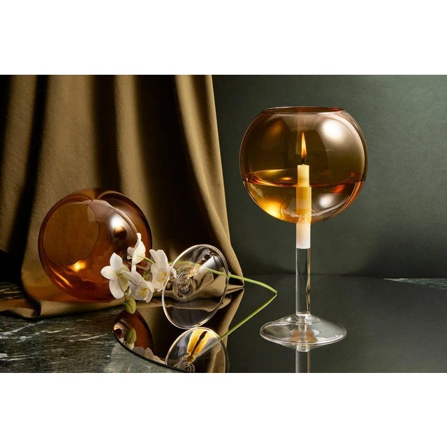 The candleholder is mouth blown on a lathe. Jim was inspired to design a candleholder while watching the film 'The...