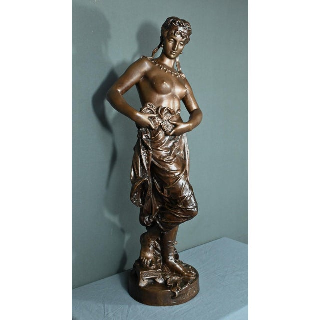 Large bronze sculpture with brown patina by the artist Charles-Auguste LeBourg representing Nycia emerging from the Bath....