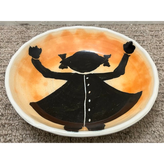 Up for sale is a Kurt Anderson Pottery Contemporary Style Girl with Hands Raised Motif Shallow Bowl (21st Century)...