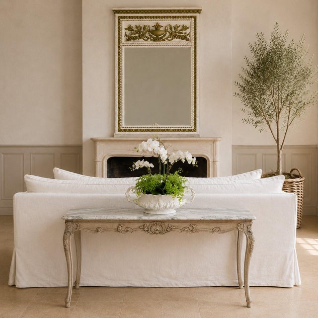 An antique 19th century Louis XV style table with an original honed marble top and a carefully stripped finish that...