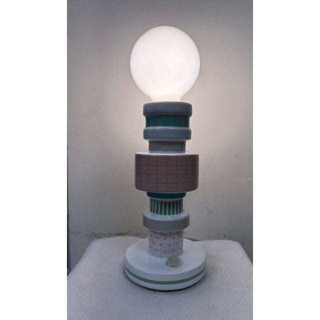 “Moresque” porcelain lamp with cloth cord and plastic LED bulb design by Alessandro Zambelli for Seletti. The bottom is...